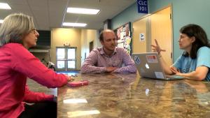 EnCircle Technologies owners Becky Llorens, left, and Teri Walden, right, consult Collin Bunch, their MU Extension business development program counselor.MU Extension