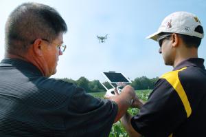 Kent Shannon, left, profiled by Successful Farming magazine’s November 2017 issue as an ‘exceptional extension specialist,’ shows agronomy specialist Dhruba Dhakal how to use a drone to take aerial images of a soybean field in the Missouri Strip Trial ProPhoto by Linda Geist