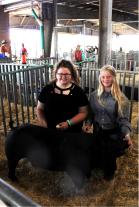 From left, Ella Johnson,17, and Maci Johnson, 15, with their pig Rufus.