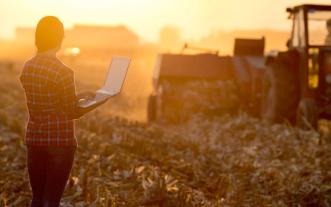 farmer in field with laptop