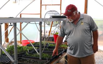 Larry Roberts in greenhouse