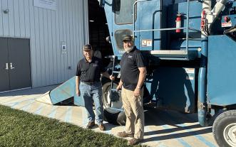Wayne Flanary and Jim Crawford in front of new plot combine.