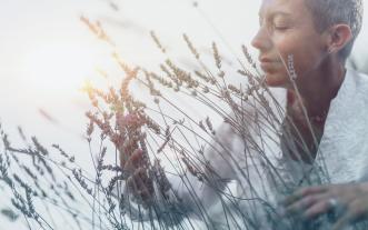 Mindful Woman Feeling Good, Enjoying the Scent of Lavender Flowers