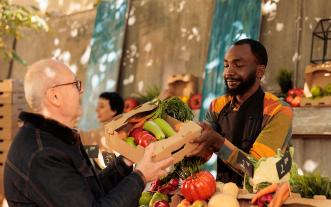 Man buying produce at a farmers market.
