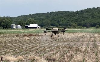 Drone flying over field