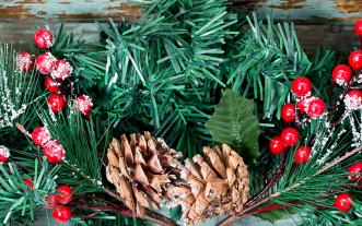 Christmas decoration of mistletoe, holly with berries, ivy and pine cones