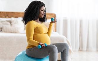 Pregnant woman exercising at home