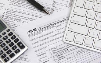 1040 tax form, calculator and keyboard