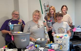 Five people with donated items they've helped collect
