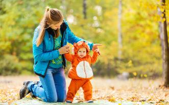 Child in Halloween costume with parent