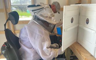 Fred Marjoda handling a beehive