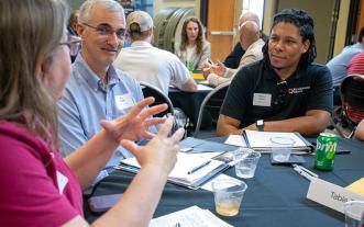 People sitting around a table at a conference