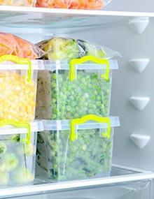 Frozen vegetables stacked neatly in a freezer.