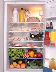 Open refrigerator full of food.