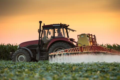 Tractor spraying field