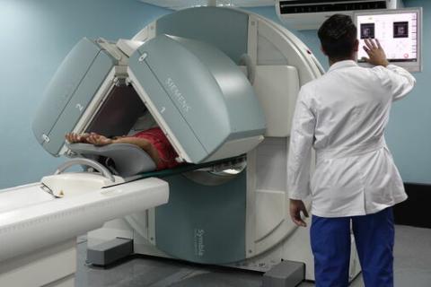Technician viewing screen by MRI