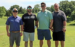 Four men on a golf course