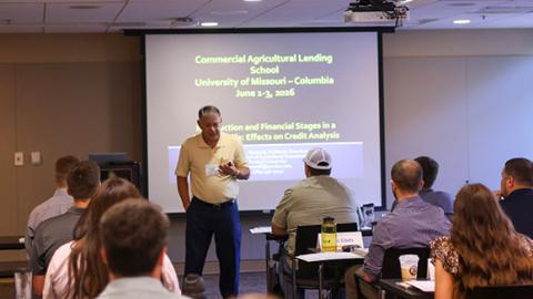 A man speaking in front of a class.