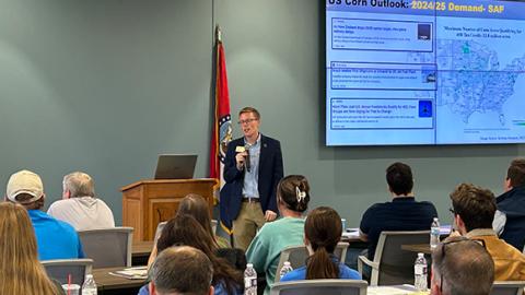 A man speaking in front of a group.
