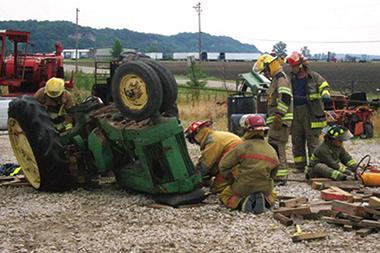 Fire fighters working a tractor accident rescue.