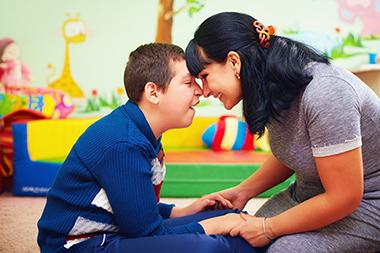 Mother playing with her son who has a developmental disability