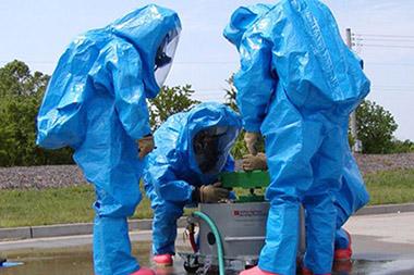 Three people in hazmat suits.