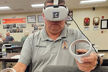 Man with a virtual reality headset on in a classroom.