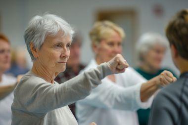 senior citizens with fists out in self defense course