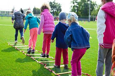 Kids playing on a mobility ladder.