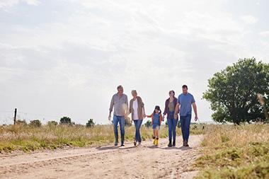 A family walking down a gravel road.