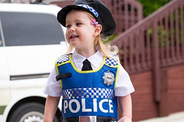 Young girl wearing police uniform
