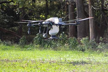 Drone hovering over field