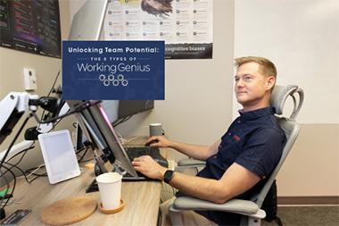A man sitting at a desk with a laptop.