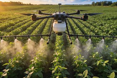 Drone flying over a field.