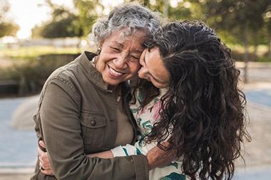 Adult woman embracing her mother