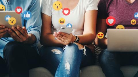 social media reactions floating from people's phones