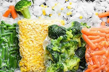 Bags of frozen green beans, corn, broccoli and carrots surrounded by ice.