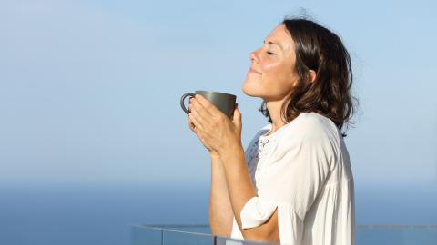 woman relaxing during summer on balcony