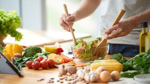 person tossing salad