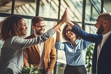 A corporate team high fiving