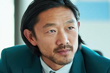 A closeup of a suited man's face