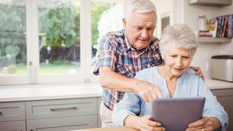 senior couple looking at a laptop