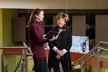 Two women reviewing a booklet together