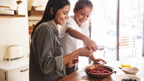 child and adult cooking
