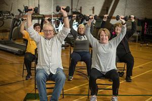 older people exercising in a class