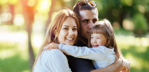 family of three hugging