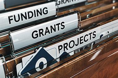 File folders with tabs for Funding, Grants, and Projects