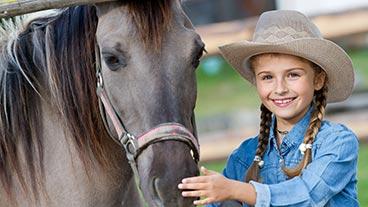 Girl petting horse.