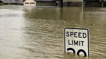 speed sign under flood water