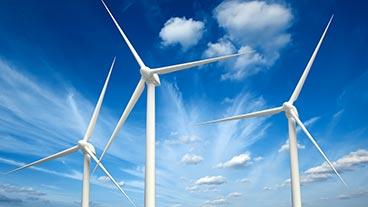 Wind turbines in a blue sky.